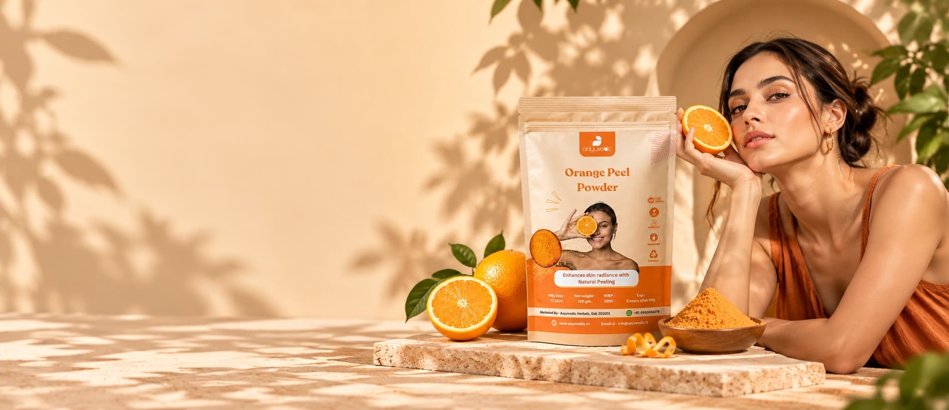 Orange Peel Powder pouch with fresh oranges, beside a woman holding an orange slice